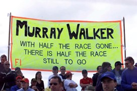 A group of people standing in front of a sign

Description automatically generated